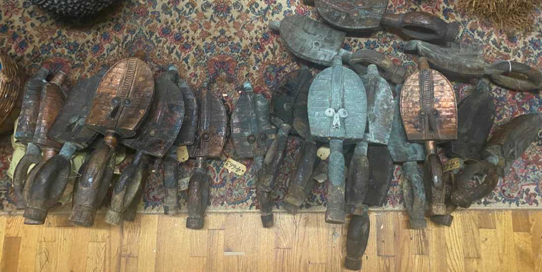 Large Lot Kota Mahongwe Reliquary Guardians: Lot of 24 Kota Mahongwe style reliquary guardian figures, all with concave, leaf-shaped faces clad with strips of copper, with bulging eyes set close together above pointed nose. Tallest approx. 21 1/