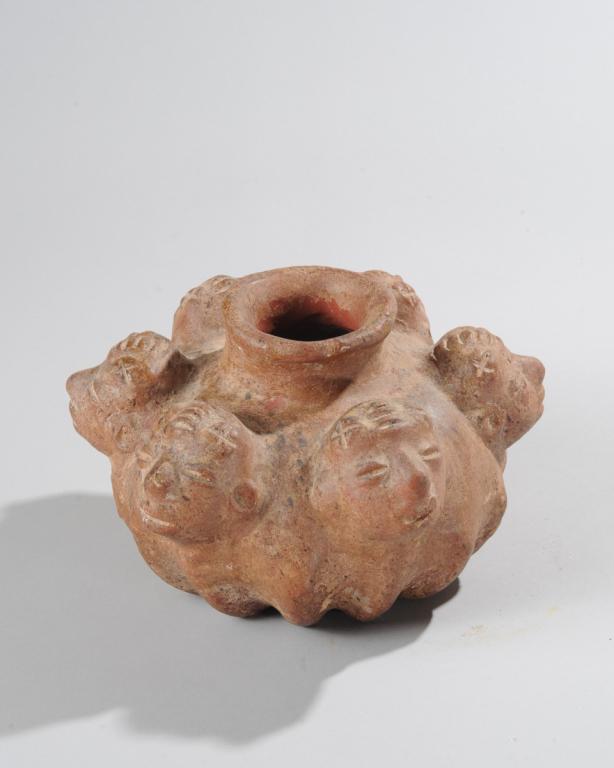 Six Faces Pot: Terracotta pot with six faces around the neck, lobed lower half. Approx. 6" H, 9" W. Provenance: Estate of Thomas McNemar, (1931-2020.) McNemar lived and collected throughout Central and West Africa i