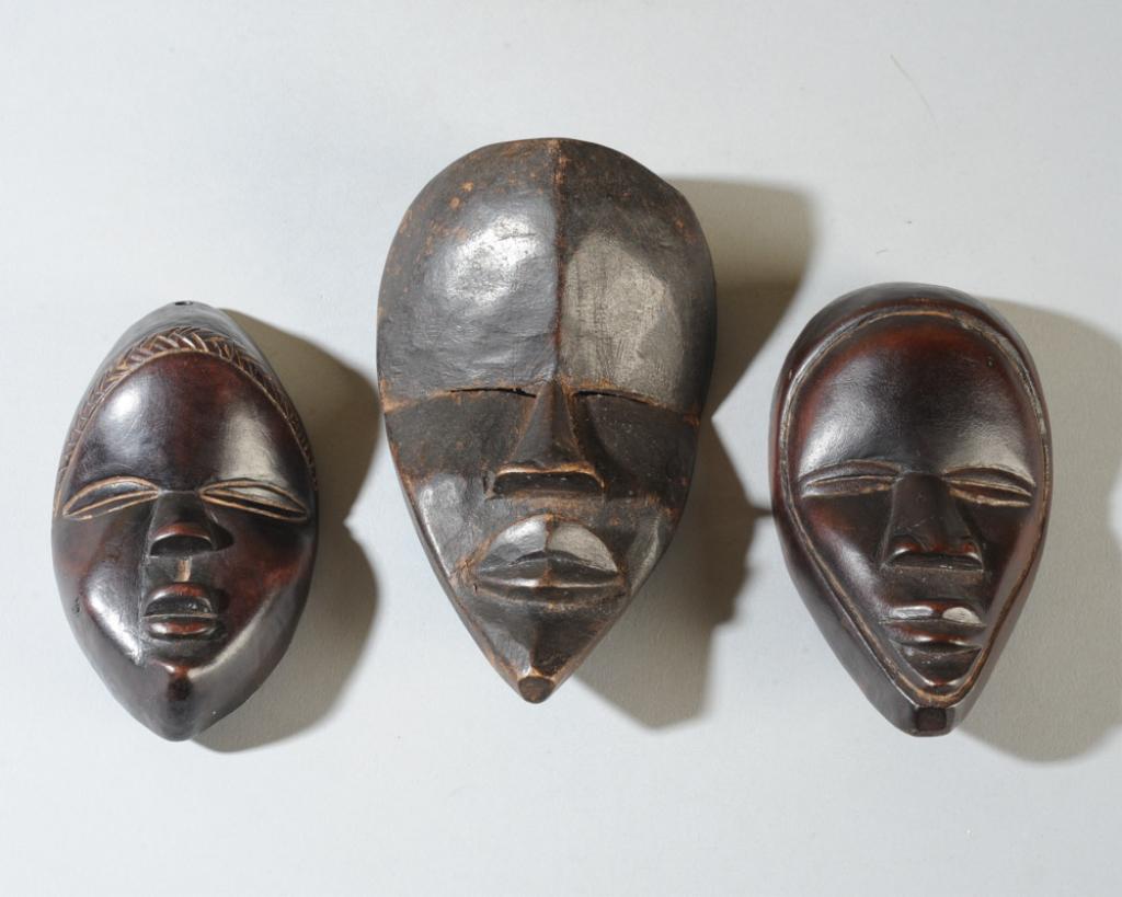 Three Dan Passport / Miniature Masks: Dan people, Liberia. Approx. 6" x 3 1/2", 5" x 3", and 4 5/8" x 2 5/8". Provenance: Estate of Thomas McNemar, (1931-2020.) McNemar lived and collected throughout Central and West Africa in the 1960s a