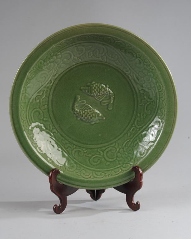 Large Chinese Celadon 'Twin Fish' Bowl: Large dark green celadon bowl with auspicious twin fish in relief in the center, the cavetto with carved vines, and with flat everted rim. Approx. 16" diameter.