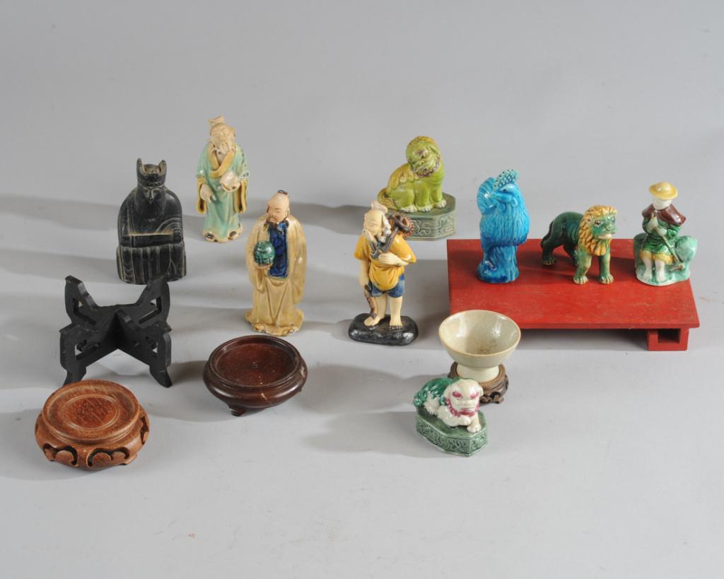 Mixed Lot Chinese Porcelain Miniatures: Late Qing or Republic period porcelain figures including a recumbent foo dog, a seated green foo dog, a turquoise blue rooster, a lion, a seated fisherman or sage, and a small celadon porcelain wine c