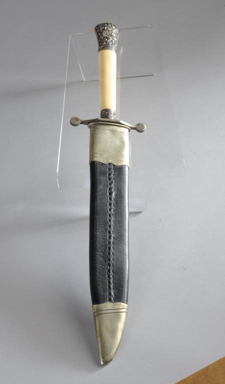 Evans & Co. Sheffield Style Blade: Blade marked Evans & Co, 12 Old Fish Street, London. Repousse sterling silver bound bone handle with English hallmarks, Silversmith's mark HH. With scabbard. Approx. 17" Long. Provenance: The estate o