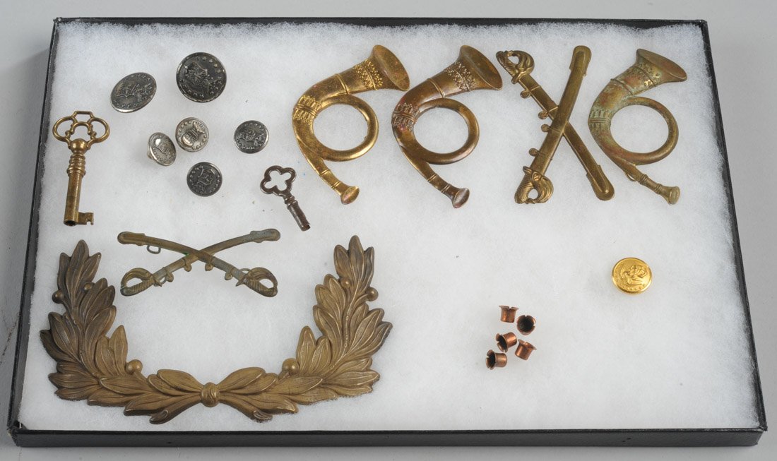 Civil War Hat Badge Mixed Grouping, etc.: To include three infantry badges, two cavalry badges, one wreath-form badge, along with several buttons, musket caps, etc. Together display box, all in as-found condition.Provenance: The estate of Fre
