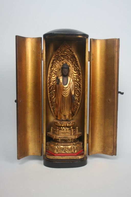 Japanese Zushi Traveling Buddhist Shrine: Black lacquer cabinet with painted and gilded bodhisattva. Few minor flakes on the exterior of the cabinet. Overall height approx. 11 1/2", figure is 10" high.
