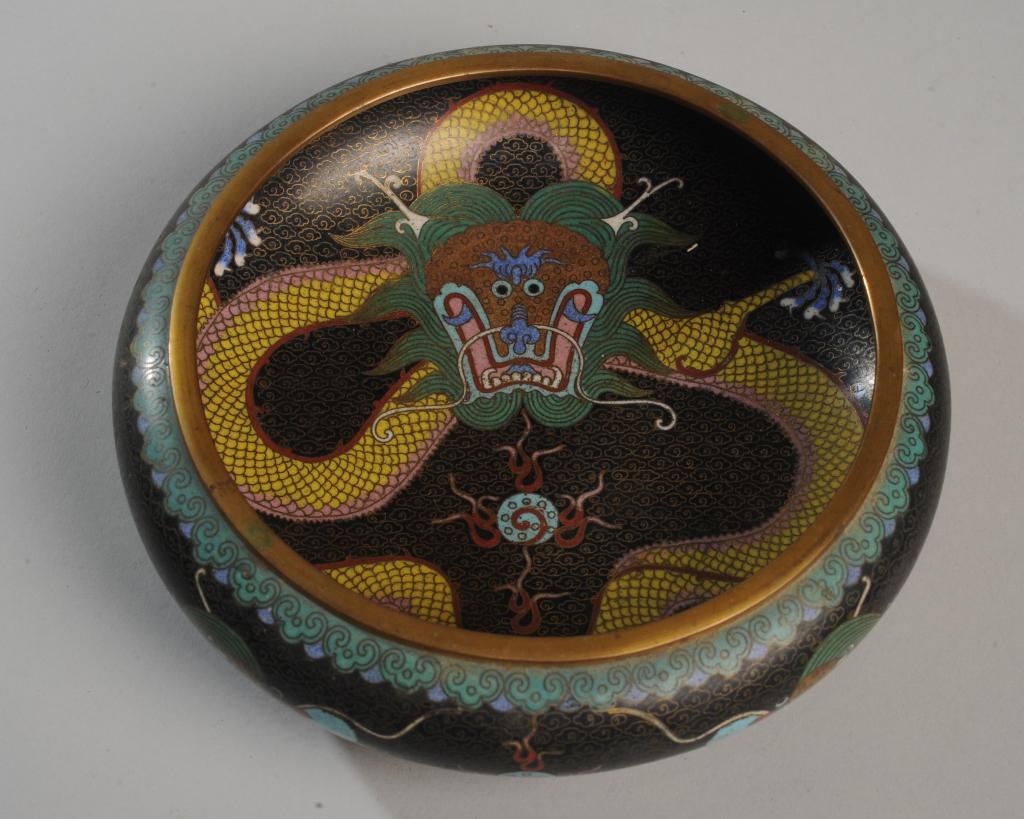 Chinese Cloisonne Dragon Bowl: low bowl or censer, the center and sides with five-toed yellow dragons on a black ground chasing flaming pearls, with cloud and wave borders. Base turquoise blue. Unmarked. Approx. 8" diameter, 2 1/2"