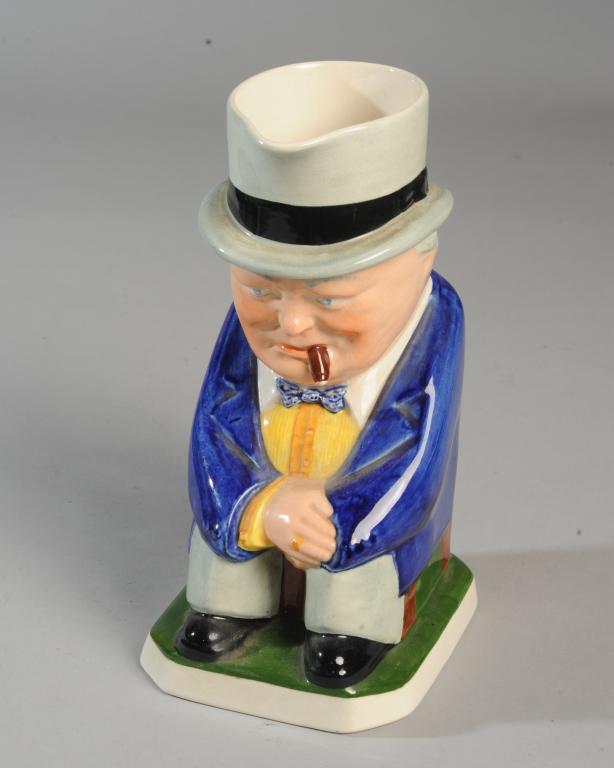 Spode Copeland Churchill Toby Mug: Toby mug in the form of a seated Winston Churchill, cigar clenched between his teeth. Back of figure at base with impressed designer's mark: ERIC OLSEN N.R.D. Base marked: COPELAND SPODE ENGLAND. Appr