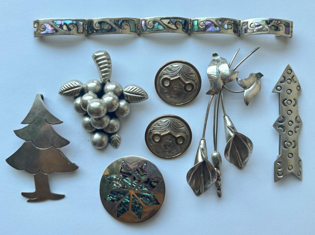 Mixed Grouping Mexican Sterling Jewelry: Including four sterling brooches, sterling and abalone bracelet, pair of sterling on bronze earrings (without backs), sterling and abalone brooch. All in as-found condition.