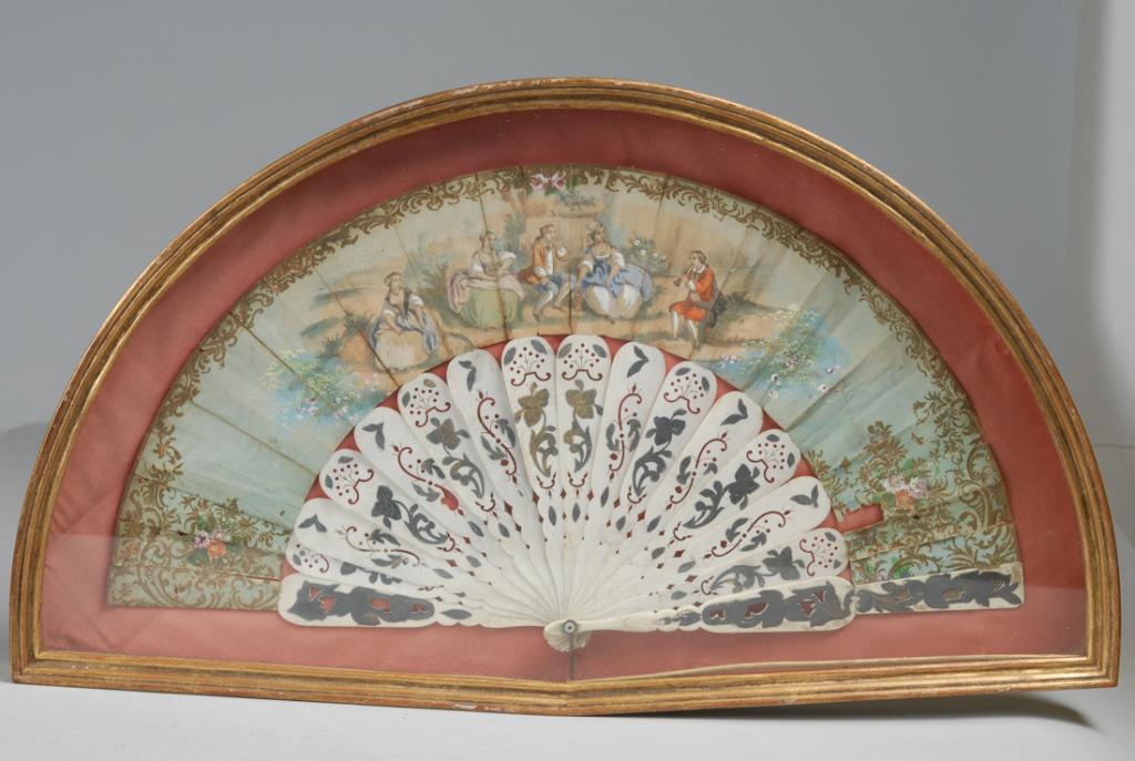18th or 19th C. French Hand Fan: With reticulated and gilt bone sticks, the paper leaf with baroque style figures listening to a young man play a horn. Hand painted and drawn with gilt. In shadowbox frame. Frame, approx. 23 1/2" X 13