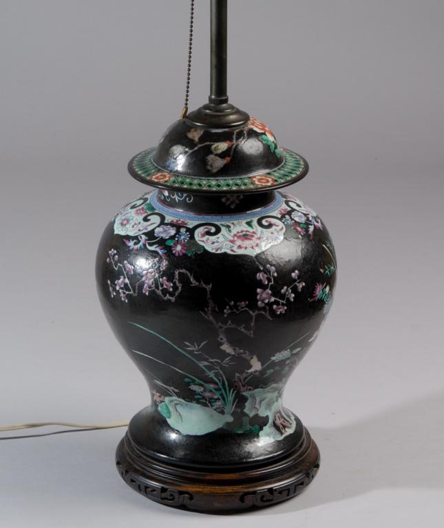 Chinese Famille Verte Black Ground Jar as Lamp: Antique Chinese porcelain baluster jar and cover finely painted with a design of geese among flowering plants and rockwork, with floral motif cloud border and diaper patterns. Converted to lamp in the