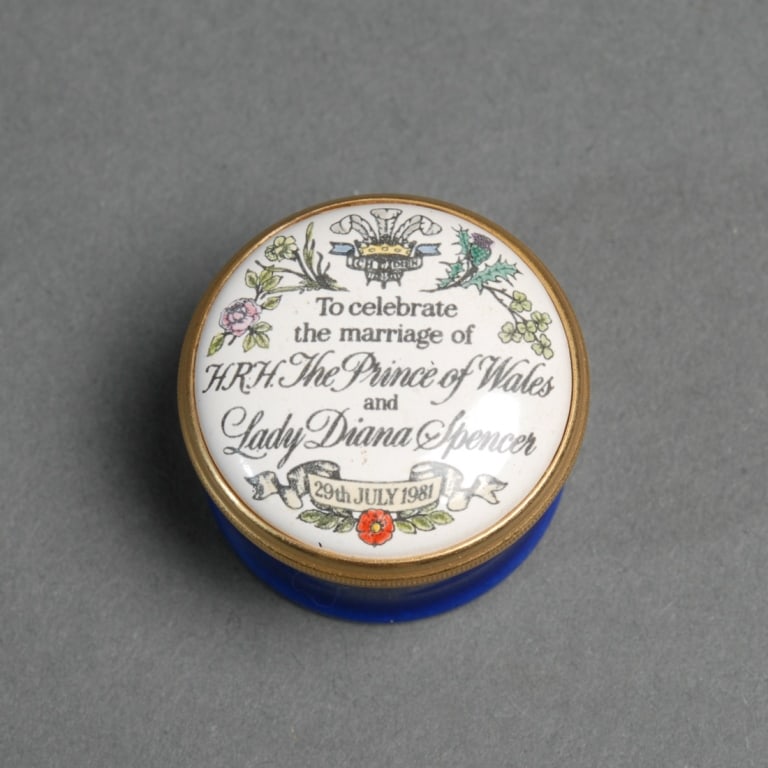 Halcyon Days Marriage of Charles & Diana: Halcyon Days enamel pill box "to celebrate the marriage of H.R.H. The Prince of Wales and Lady Diana Spencer 29th July 1981". In original box. Pill box dia: approx. 1 1/8". Box: approx. 2 3/4" x 2 3/4