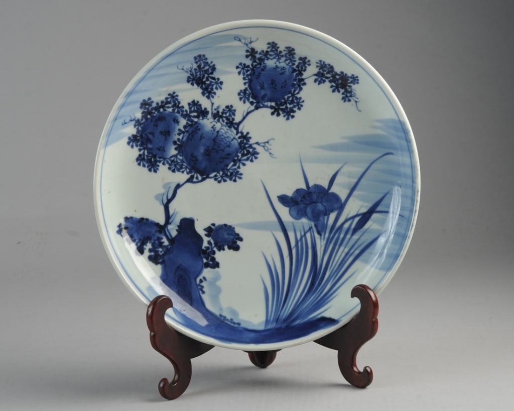 Edo Arita Blue & White Japanese Charger: With blossoming tree, rockwork,and flower in underglaze blue. Underside with linear, cloud-like decoration. Unglazed foot ring with kiln grit, seven kiln spurs to base. Late Edo / mid 19th C. Approx. 