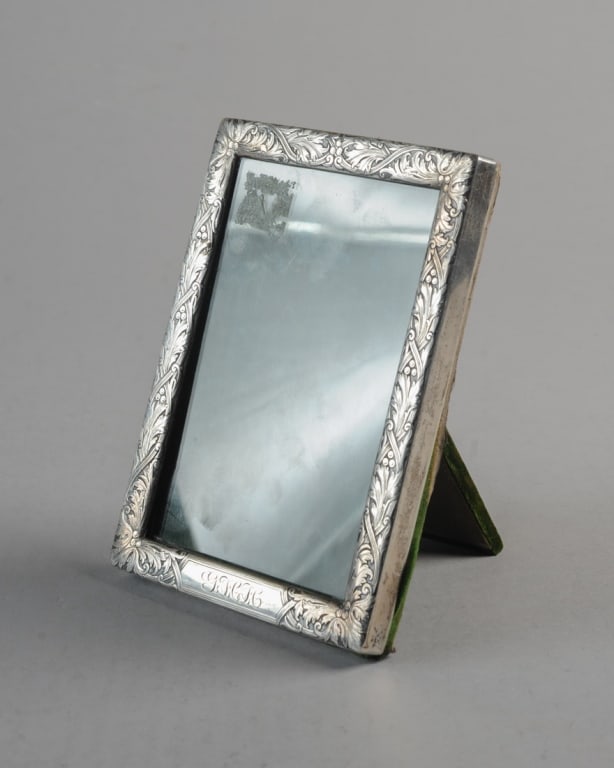 Sterling Silver Picture Frame: Monogrammed, with floral design, attached wood railings to hold front glass in place.Approx. 6 1/4" x 4 5/8".