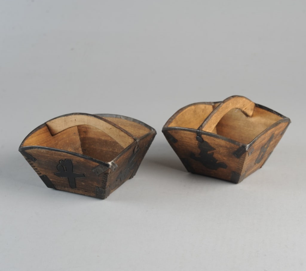 Pair Chinese Rice Grain Measures: Four-sided wooden rice measure baskets with handles, metal reinforced edges and corners, each of the four sides with a Chinese character carved into the surface and blackened.