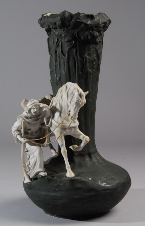 Imperial Amphora Art Nouveau Orientalist Vase: Large Art Nouveau Orientalist vase with the figure of an Arab leading a horse, the body of the vase molded in the form of trees. Striking matte green-black surface to vase, with glossy white interior,