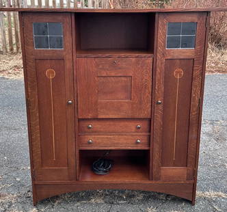 Stickley Harvey Ellis Fall Front Desk / Bookcase: Stickley Harvey Ellis Collection oak fall-front desk flanked by a pair of doors with delicate inlaid decoration and glass panes. Locking drop front desk opens to flat surface and four compartments abo