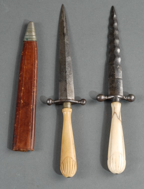 Two Bone Handle Daggers: One with wavy blade, the other with decorative design to blade, both with shell motif to handle. Blade L: approx. 5 1/8" and 4 3/4", total L: approx. 8 7/8" and 8 1/2".