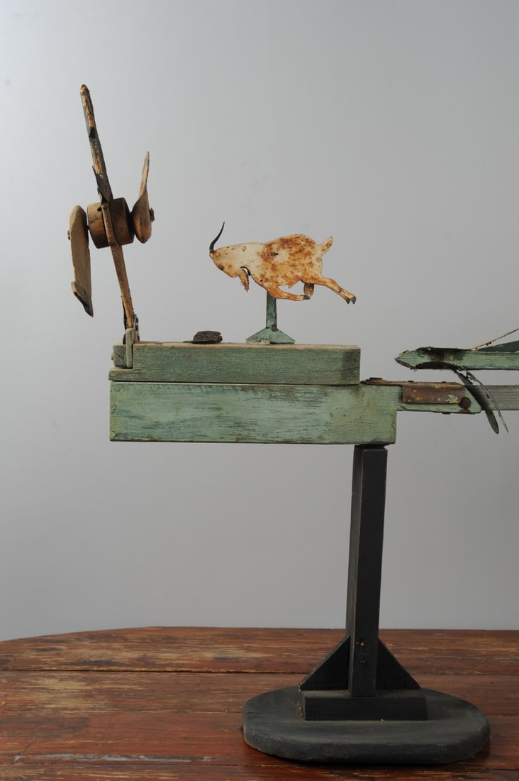 c.1910 American Folk Art Whirligig: Midwestern US folk art whirligig with a sun (or full moon?) that rolls its eyes and gnashes its teeth, and an African American man with spinning legs running away from a charging billy goat. Wood and 