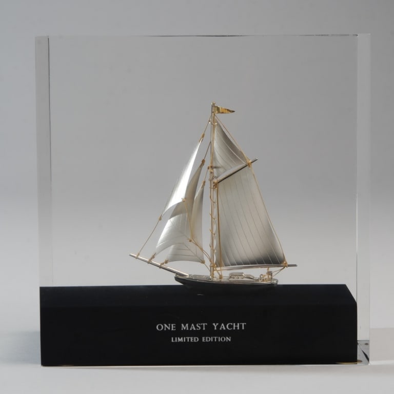 Sterling Silver Yacht Encased in Lucite: Limited edition solid sterling silver One Mast Yacht encased in lucite, by Silver Creations Ltd. Approx. 7 3/4" x 7 3/4" x 3 5/8".