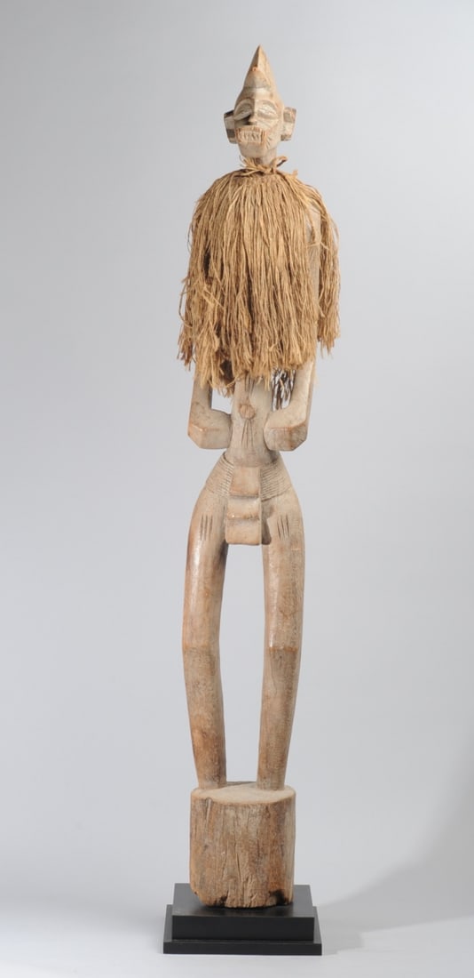 Senufo Deble Rhythm Pounder, Ivory Coast: As used by the Poro Society, the figure grasped by the upper arms and the base pounded on the ground to accompany dancers. This a male figure with typical bird-like coiffure, the small head with large