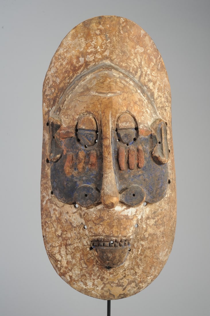 Lula Mask, D. R. Congo: Lula mask of the type thought to provide protection during initiation rites. Somewhat flat mask with oval eyes surrounded by small perforations, 'ski jump' nose with bulbous tip and flat, disc shaped