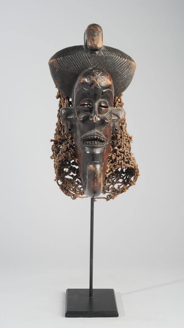 Chokwe Mwana Pwo Mask, Angola: Small Chokjwe mask, probably a Mwana Pwo female ancestor mask, the exaggerated bulge of the forehead and hook in the chin in the narrow face echoing the birdlike forward projecting element of the coif