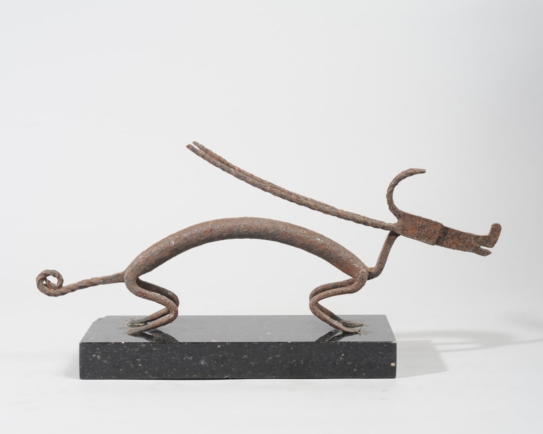Bamana Bronze Chi Wara Antelope Figure, Mali: Horizontal bronze antelope looking ready to spring. Twisted horns, curled tail. Includes black granite base. Figure, approx. 15 1/4" L x 1 3/4" W. x 6 1/4" H Size of base, approx. 10" L x 4" W x 1" H.