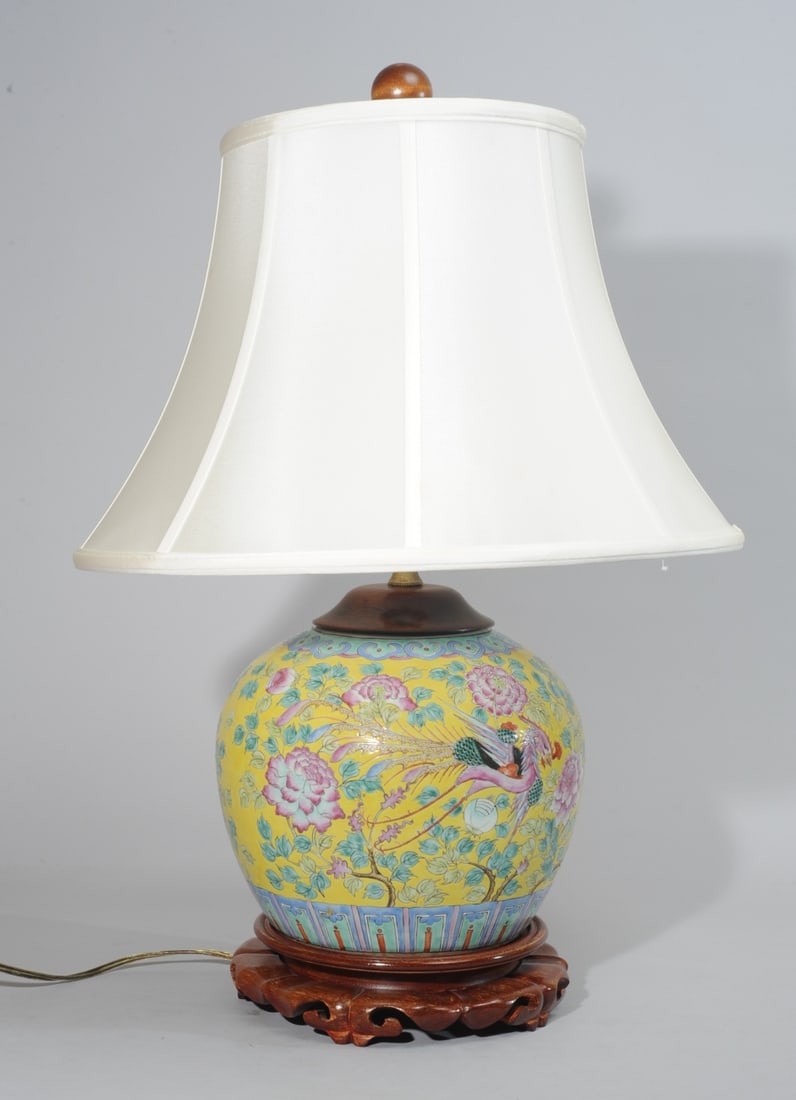 Chinese Yellow Ground Phoenix Jar as Lamp: Chinese ginger jar with phoenix among flowers in famille rose enamels on a yellow ground, mounted as lamp. Jar probably Republic period. With wooden base and cover. Works. Height to top of finial appr
