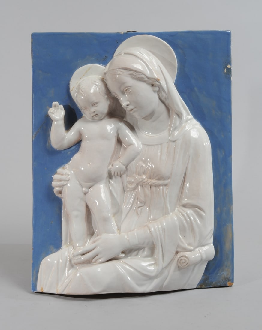 Italian Faience Madonna & Child after Della Robbia: Italian majolica plaque with white glazed mother and child in high relief against a blue glazed ground, after the original by Luca Della Robbia, (1399/1400-1482.) Incised triangular mark with F M U Z