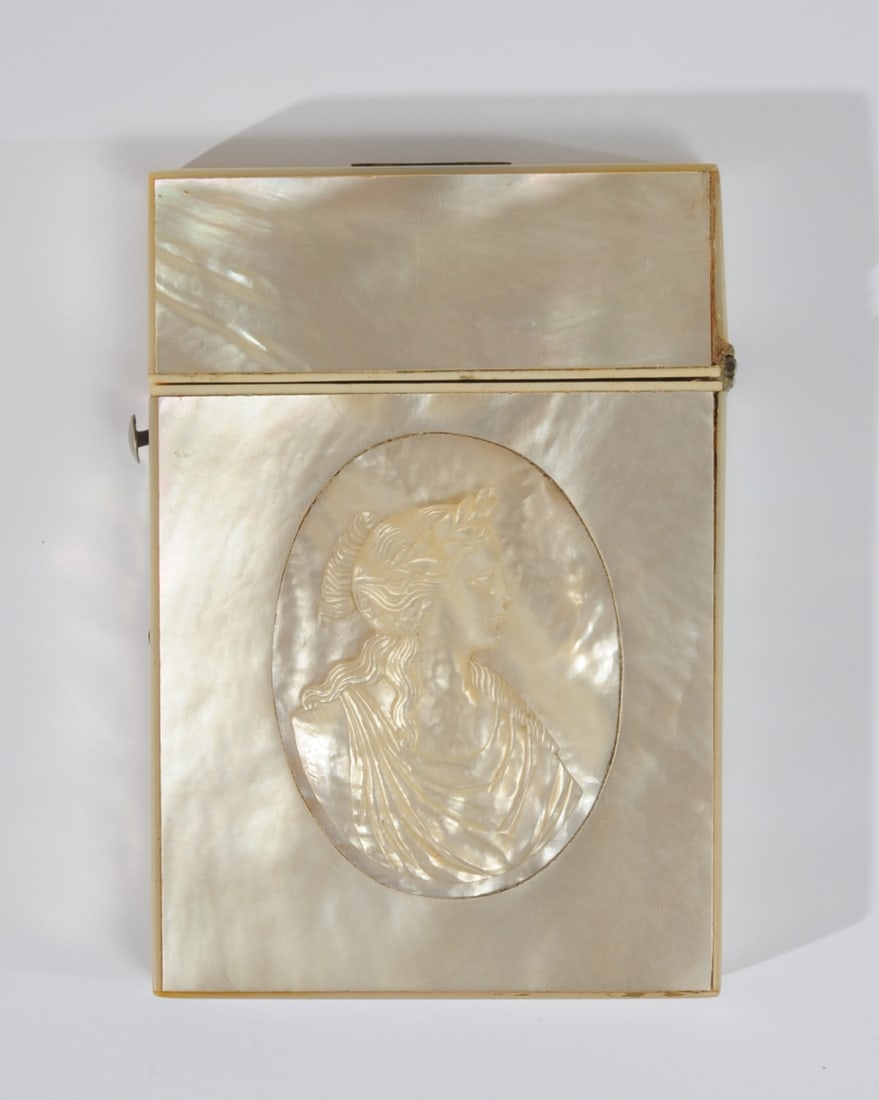 19th C. Mother of Pearl Card Case: Mid 19th C. calling card case in bone and mother of pearl, with neoclassical cameo showing a female deity. Interior lined with dark blue velvet. Approx. 3 7/8" x 3 5/8" x 5/8".