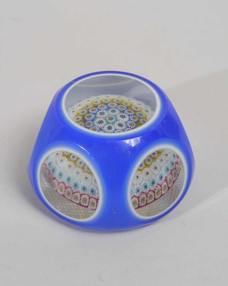 Millefleur Art Glass Paperweight Murano?: Glass paperweight with central millefleur sphere encased blue over white over clear glass, with six round facet windows. Incised cross-hatch base. No signature found. Approx. 2 1/2" H.