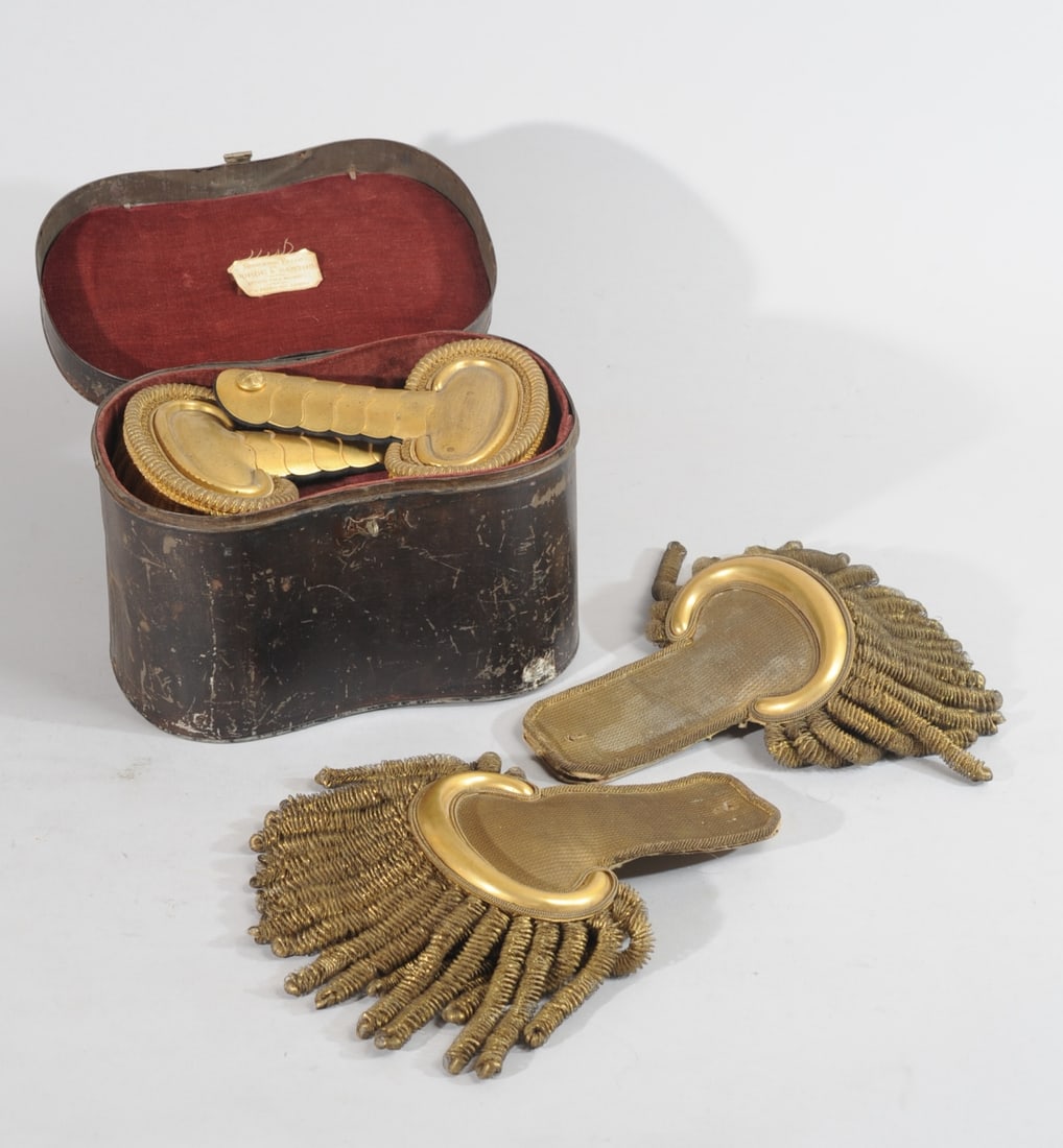 Antique Portuguese Epaulettes in Case +: Pair of gilt epaulettes having a top button with crossed cannons, in metal case (scratches / wear to case) marked for "Sirgueiria Bello / de / Jorge & Santos / Artigos Para Militares / PD Pedro 103 - 