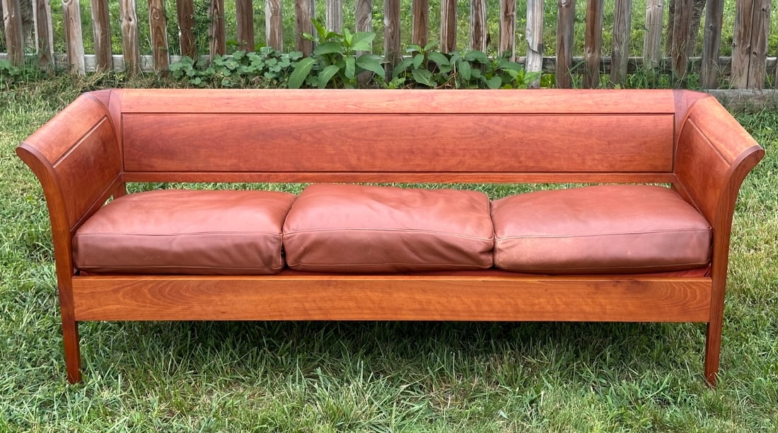 Thomas Moser 3-Place Sofia Sofa: Cherry, with leather upholstered cushions, signed. Together with a hardcover copy of the book "Thos. Moser: Artistry in Wood" by Thomas F. Moser and Brad Lemley. From the Moser website - "Perhaps no o