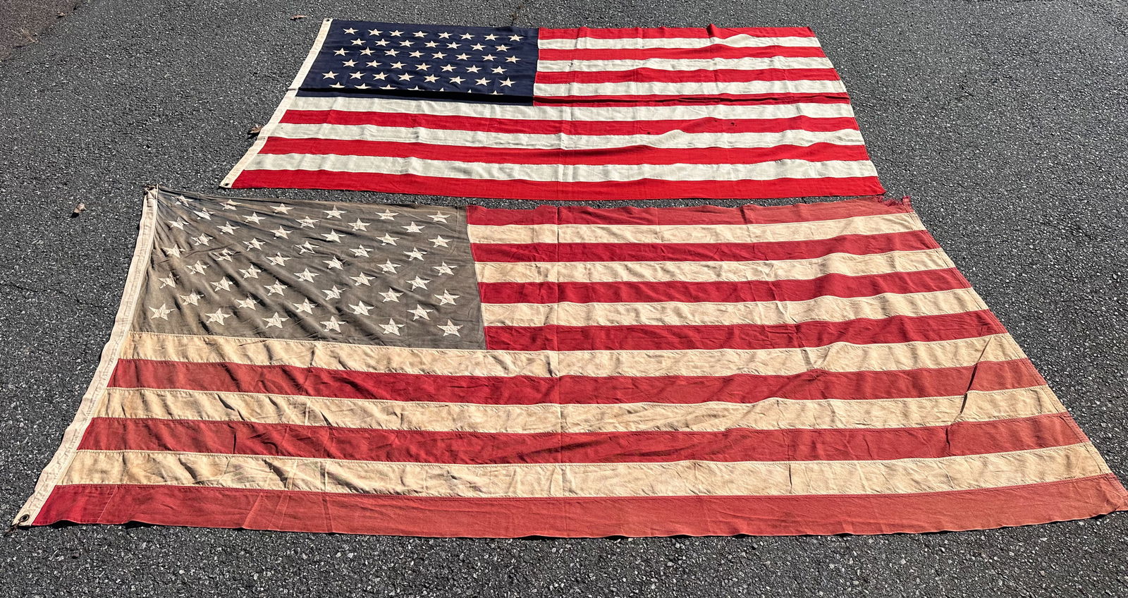 45-Star American Flag & 50-Star Flag: 45-star flag together with a vintage 50-star flag. Some weathering, discoloration, small holes / tears. Largest: approx.