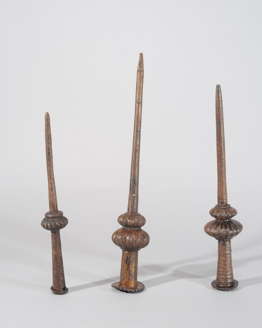 Three 18th C. Mughal Spear End Mounts: Mughal steel spear butts, used to counterbalance the weapon's weight opposite the blade end. The two larger mounts with incised decoration. 18th C., possibly earlier. Largest approx. 16 1/2" L. Proven