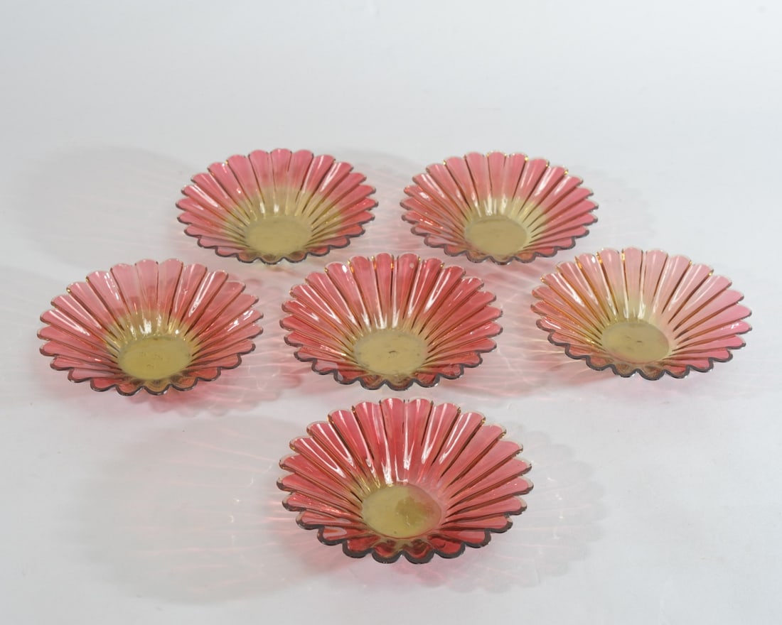 6 Amberina Glass Sherbet Bowls: Six daisy-shaped glass bowls, yellow at the center shifting to red, with scalloped rim. Small, nibble-sized rim chips. Approx. 6 5/8" D, 1 3/8" H. Provenance: the estate of John Long, highly regarded 