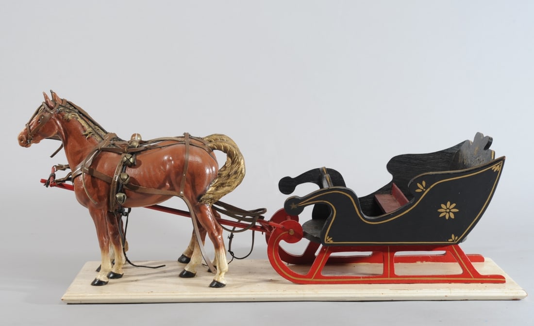 Cast Iron Horse Doorstops with Wooden Carriage: Two painted cast iron horse doorstops (no visible maker's marks, probably Bradley & Hubbard), mounted (probably by Pennsylvania Amish) on wooden base with wooden sleigh. Some breaks to harness. Approx