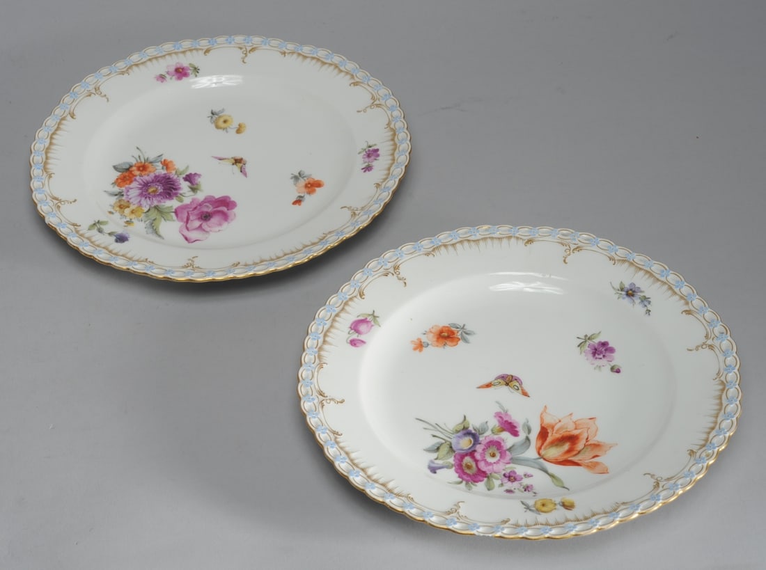 Pair 19th C. KPM Floral Plates: Hand painted with scattered flowers and butterflies, and with a scalloped edge with a relief border of blue flowers joined by gilt rings. Both marked scepter in underglaze blue topped by sn underglaze