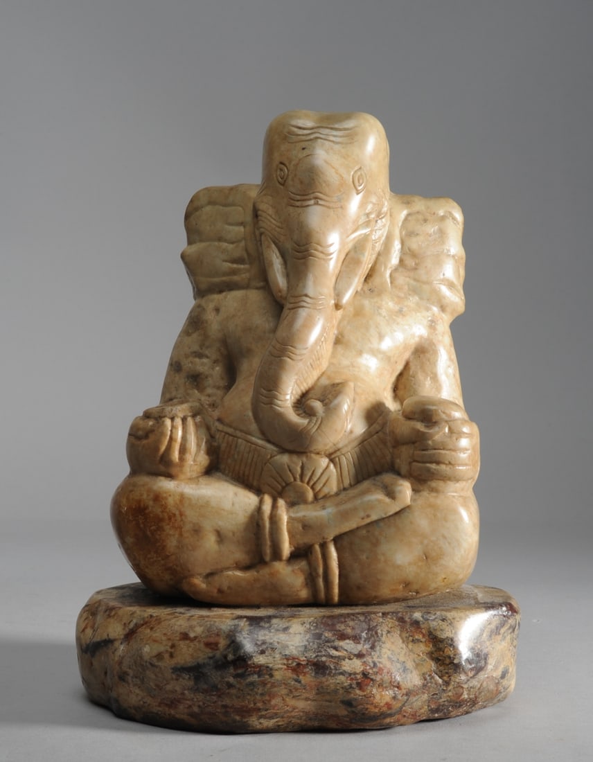 Carved Soapstone Figure of Ganesh: Carved soapstone statue of the Hindu god, Lord Ganesh, seated in padmasana pose and holding rounded objects in his hands. India. Approx. 10" H.