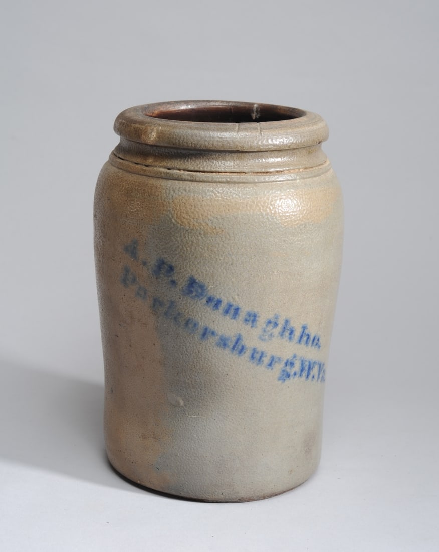 A. P. Donaghho Crock, Parkersburg WV: Grey salt glazed stoneware crock with "A. P. Donaghho / Parkersburg, W. Va" stenciled diagonally in cobalt blue. Crock bulges slightly towards the top, with incised double line and rolled rim. concave