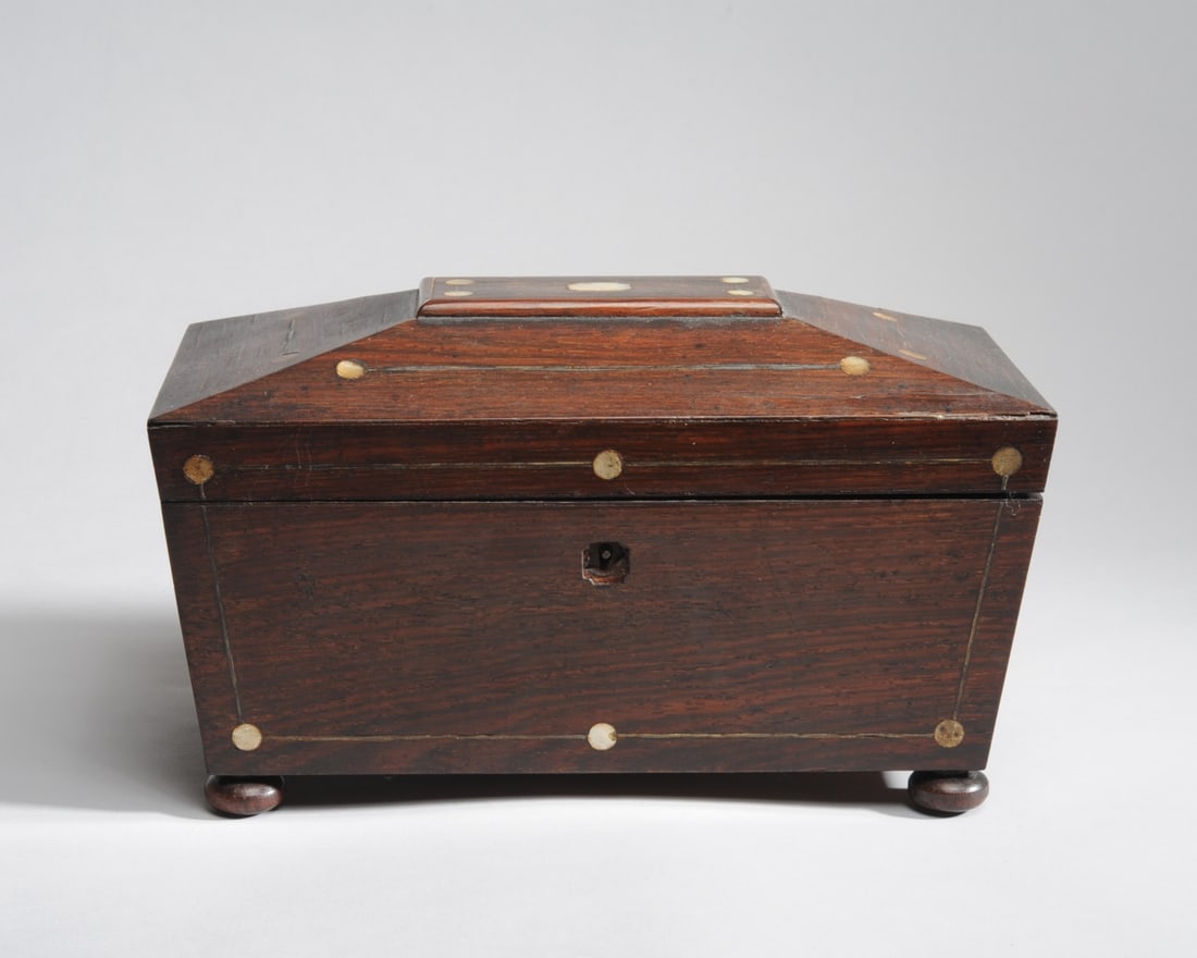 Antique English Mahogany & MOP Tea Caddy: Sarcophagus form tea caddy with mother of pearl inlay. Purple velvet lining to underside of lid, on bun feet, missing original glass insert. H: approx. 7". W: approx. 11 7/8". D: approx. 5 7/8".