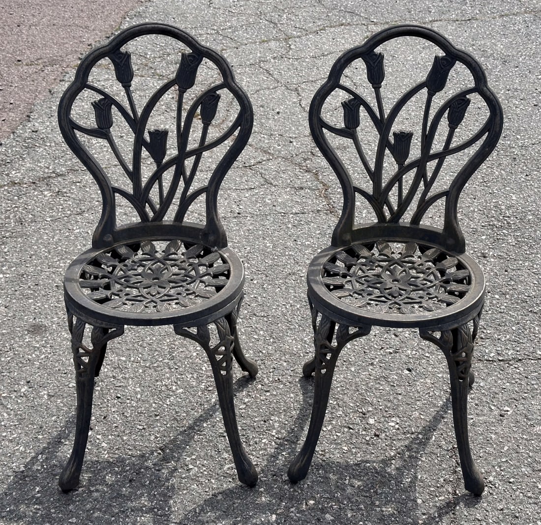 Pair Cast Aluminum Patio / Garden Chairs: The shell shaped backs with openwork tulips, reticulated seats and curved legs. Dark grey-green finish, weathered. Each approx. 33 1/2" H x 16 1/2" W x 16 1/2" D. Seat height approx. 16".