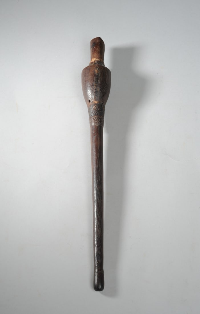 Indonesian "Feku" Flute, Timor: Carved hardwood flute or ocarina used to call free-roaming cattle and dogs. Geometric and interwoven designs carved in low relief above and below bulbous upper section. Approx. 15 3/4" L. Provenance: 