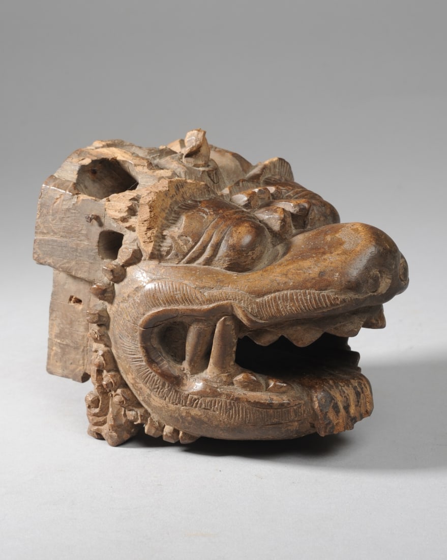 Old Indonesian Barong Mask or Carving: Carved hardwood head, likely a Balinese Barang. Dense wood finely carved with bulging eyes, the open mouth displaying sharp teeth and protruding tongue. Small carved element at top of head mounted sec
