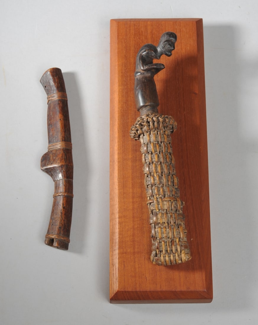 Toraja Knife, Sheath, and Ritual Knife Scabbard: Small Toraja knife, the handle in the form of a hunchback in sarong standing with elbows bent, fingertips together. The knife blade is age darkened but was regularly sharpened; traces of oxidation. Kn