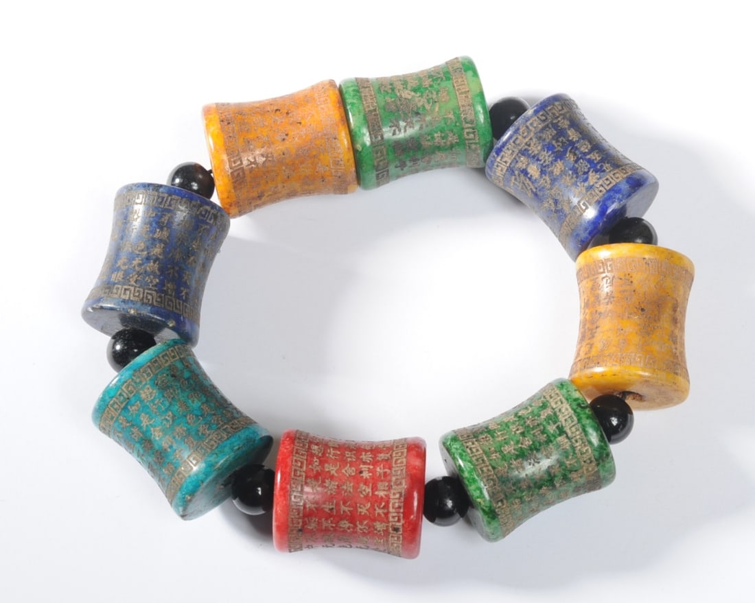 Chinese or Tibetan Hardstone Inscribed Bracelet: Bracelet of vintage large colorful hardstone beads with Buddhist inscriptions. Inner diameter approx. 3" (stretches larger.) Outer diameter approx. 4 1/2".