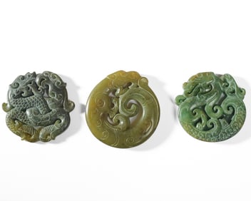 Three Chinese Carved Hardstone Dragon Pendants