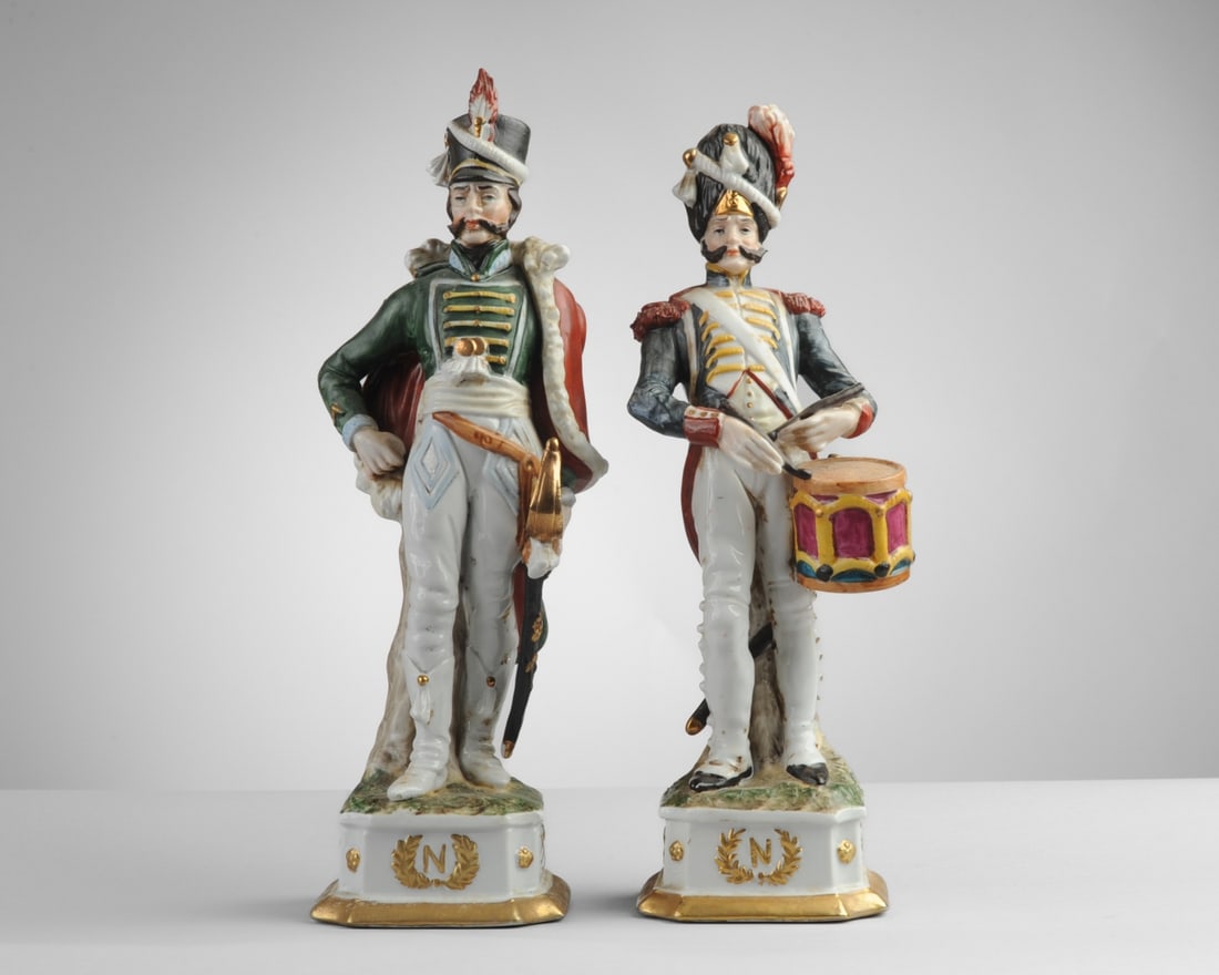 Two Capodimonte Style Di Pietro Soldiers: Porcelain Napoleonic soldiers, one with sword and one with drum. Both with wreathed N to front of base. Both marked to underside with Capodimonte style crowned N, and with Di Pietro and model numbers.