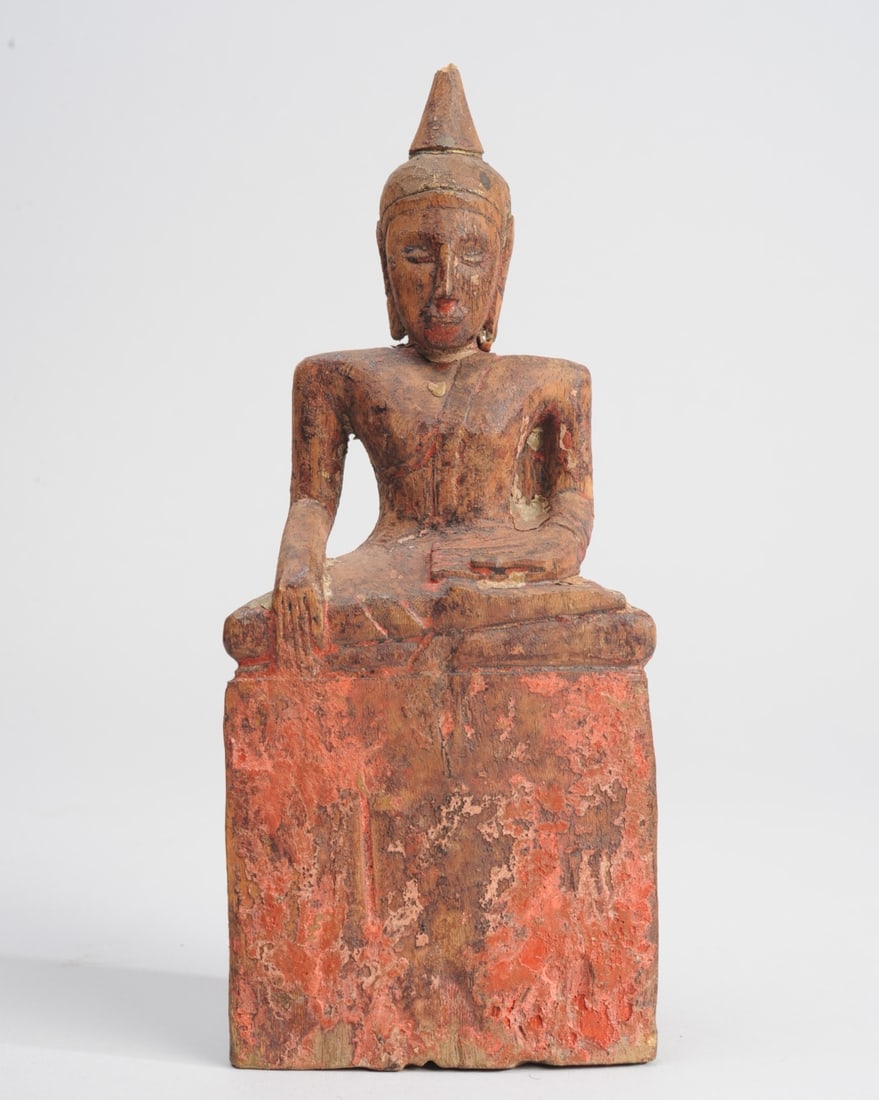 19th C. Burmese Carved Wood Buddha: Carved wood seated figure of the Buddha with some remaining red and black pigment and traces of original gilt. Chip to tip of ushnisha. Approx. 9" H. Seamless shipping is available through LiveAuction