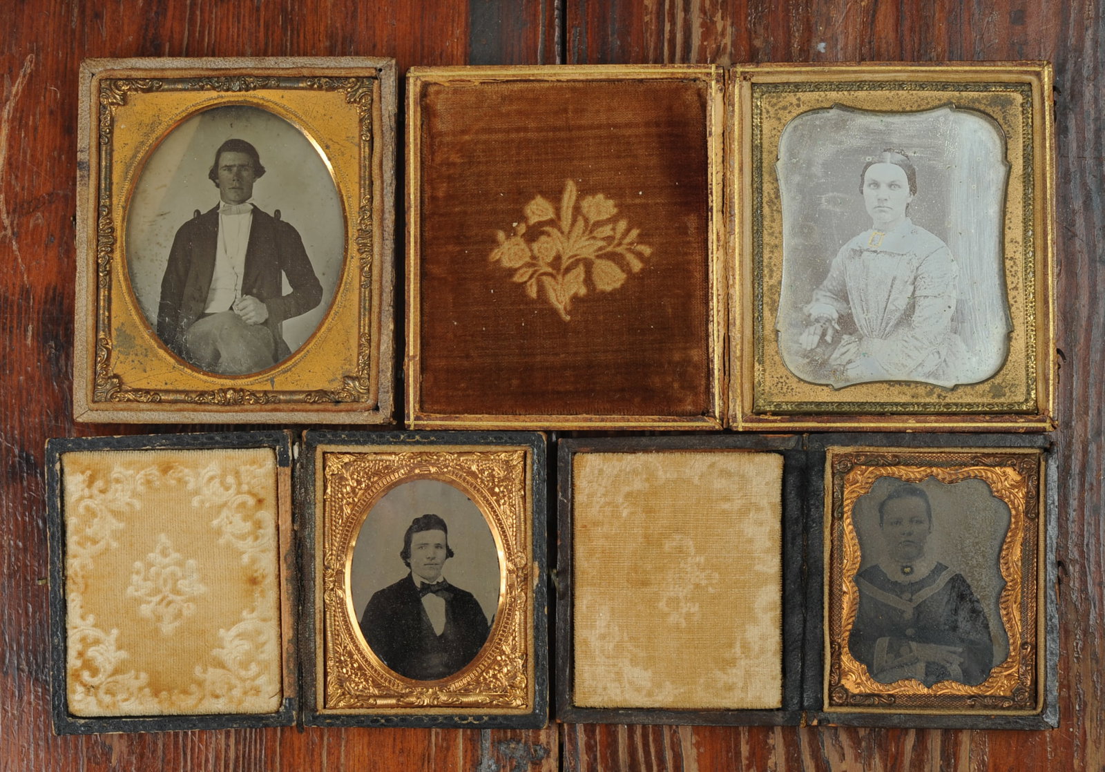 4 Cased Photos, Daguerreotype, Ambros, Tin: To include a sixth plate daguerreotype of a young woman in a gold stamped leather case, (cover of case detached but present,) a sixth plate ambrotype of a young man with dark hair and white tie, (lack