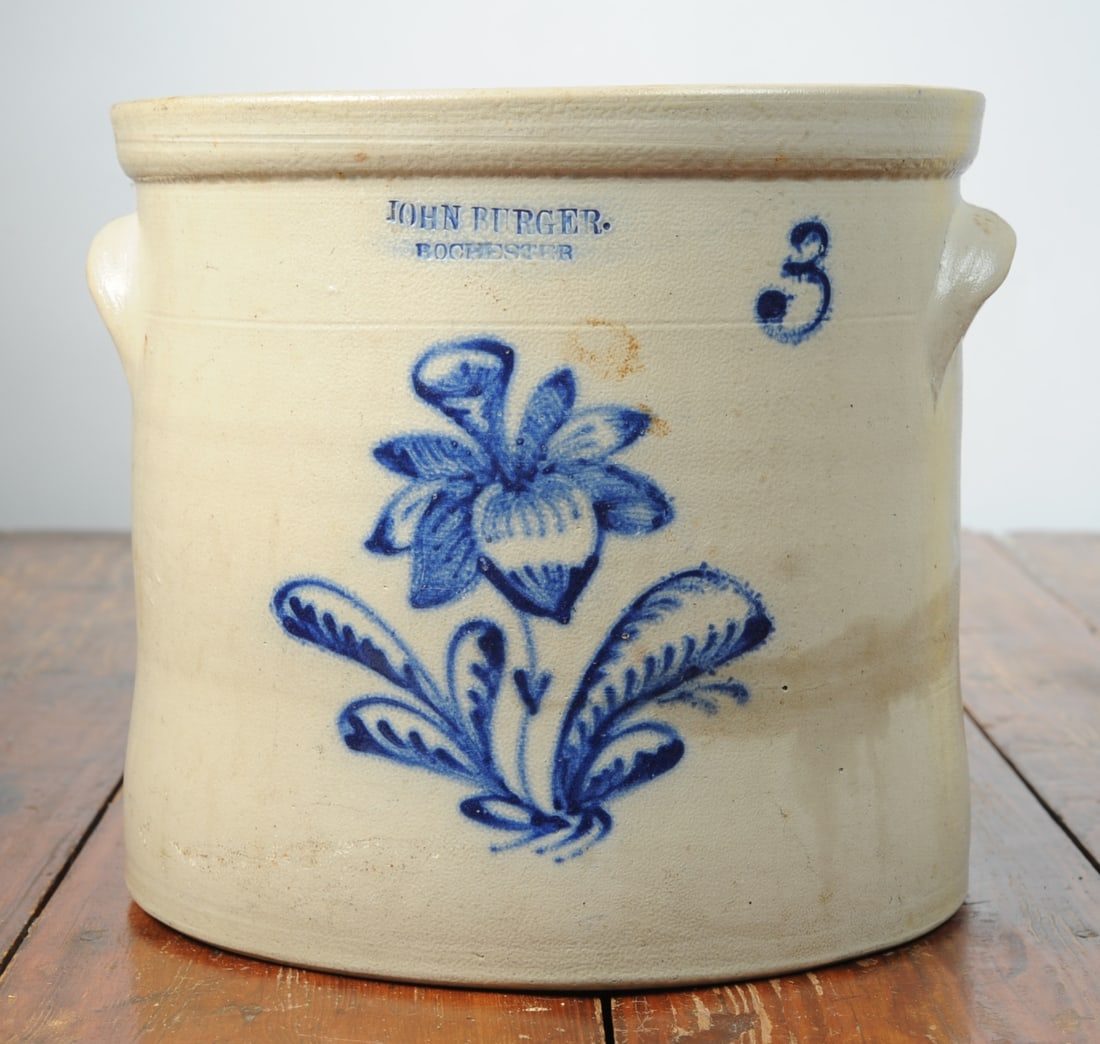 John Burger Rochester, NY 3-Gallon Crock: With floral cobalt blue decoration, marked for John Burger of Rochester, New York. Some hairlines, chips. H: approx. 2 1/8". Seamless shipping is available through LiveAuctioneers at checkout, but you